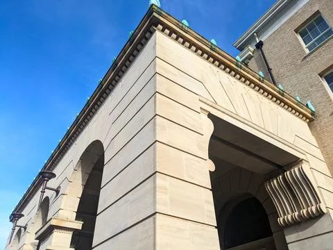 Low angle view of the neoclassical stone arches of University Arms Hotel under a Stock Photos
