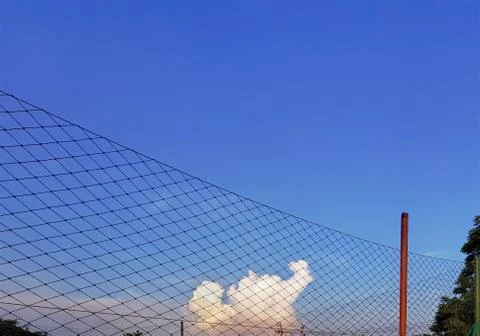 Low Angle View of Nets Around Sport Field Against Blue Cloudy Sky Stock Photos