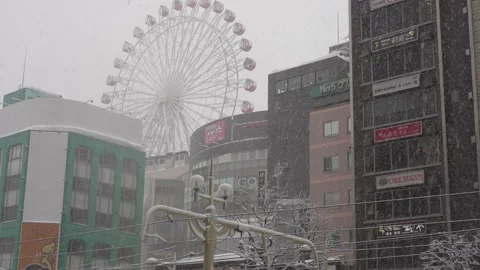 Low angle view of Norbesa Ferris wheel and buildings in Sapporo Stock-Footage 330176679