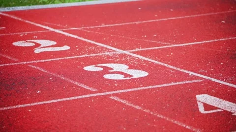 Low-Angle View of Numbered Sprint Lanes on Red Running Track in Kyiv Stadium Stock Footage 340482885