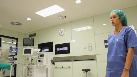 Low angle view of nurse using touch screen monitor in Modular operating theatre. 스톡 동영상 129894945