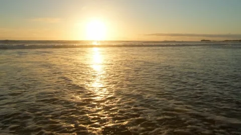 Low angle view of Ocean shore with a medical mask washing on shore by the w.. Stock Footage 253270902