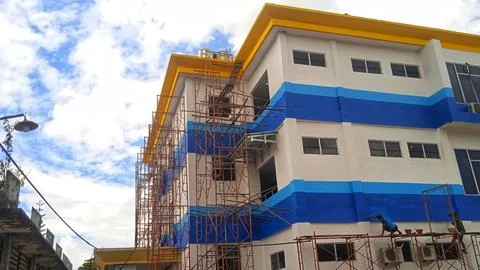 Low angle view of office building and clear blue sky background Stock Photos