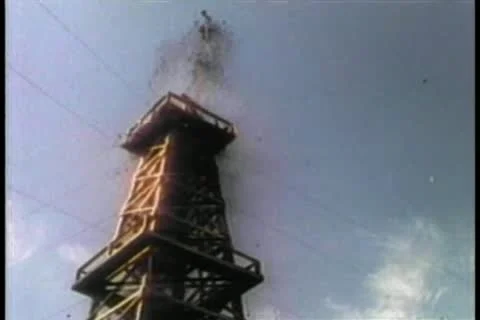 Low angle view oil gushing from derrick Stock Footage 11349248