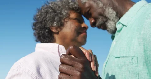 Low angle view old couple dancing at the beach Video stock 125719434
