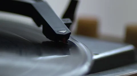 Low angle view of old fashioned turntable playing a track from black vinyl. Video stock 68934424