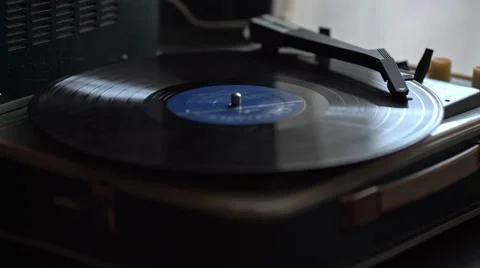 Low angle view of old fashioned turntable playing a track from black vinyl. Stock Footage 68934547