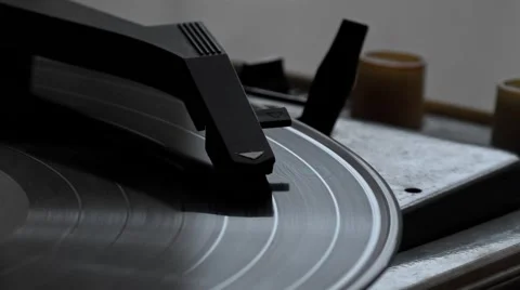 Low angle view of old fashioned turntable playing a track from black vinyl. Video stock 68934578