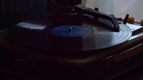 Low angle view of old fashioned turntable playing a track from black vinyl. Stock Footage 68934632