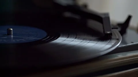 Low angle view of old fashioned turntable playing a track from black vinyl. Video stock 68934808