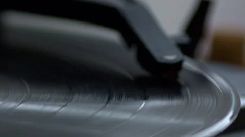 Low angle view of old fashioned turntable playing a track from black vinyl. Video stock 68934869