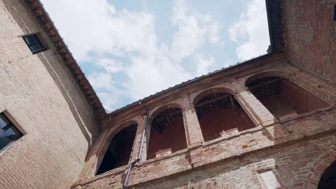 Low angle view of an old medieval castle with high brick walls, arched entrance 動画素材 345439636