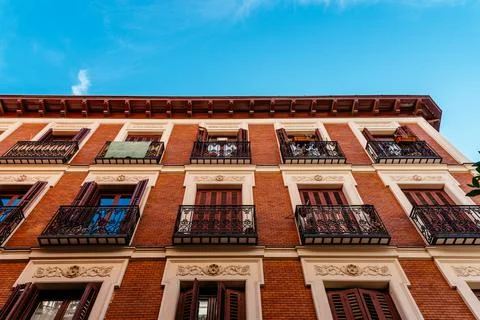 Low angle view of old recently renovated residential building against blue sky Stock Photos