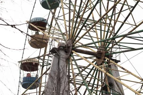 Low Angle View of Old Rusty Ferris Wheel with Colorful Passenger Gondolas a.. Stock Photos