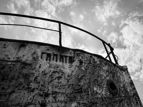 Low angle view of old ship wreckage against cloudy sky. Black and white photo. Stock Photos