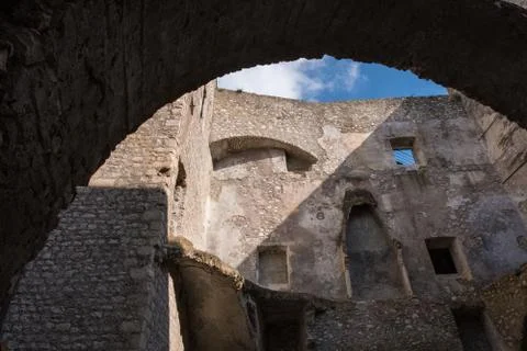 Low angle view of an old stone wall castle with blue sky background. Stock Photos