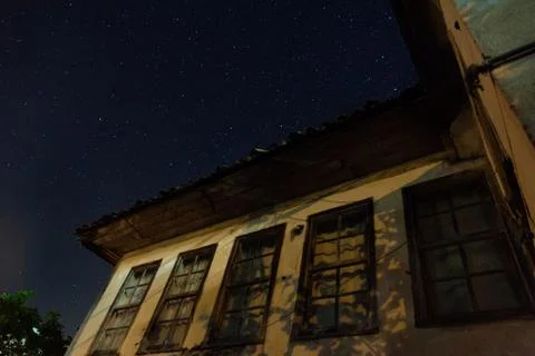 Low angle view of old Turkish house against night sky with stars Stock Photos