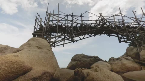 Low angle view to old wooden bamboo bridge over the rocks Stock Footage 135706847