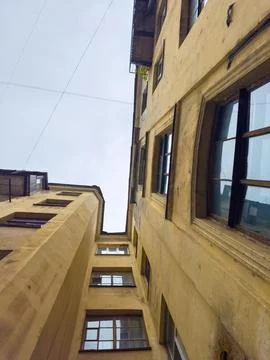 Low angle view of old yellow building with windows Stock Photos