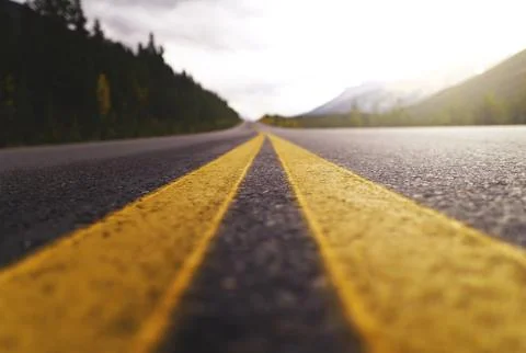Low Angle View of an Open Road with Yellow Lines Stock Photos