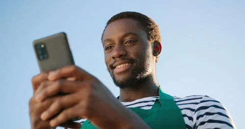 Low angle view of the optimistic multiracial farmer scientist in apron using Foto stock