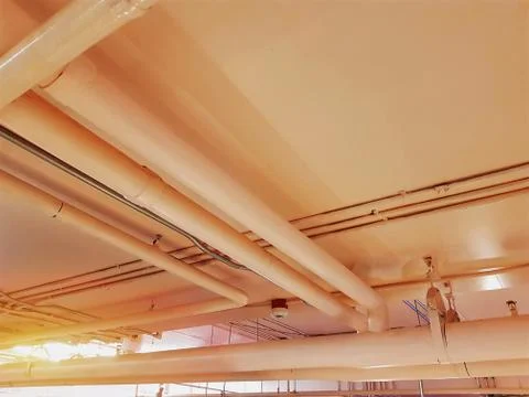 Low Angle View of Orange Piping System Under the Ceiling Foto stock