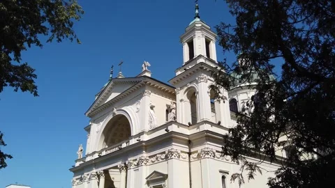 Low-angle view of ornate Catholic church with bell tower and dome outdoors Video stock 342065593