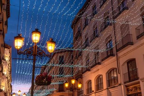 Low angle view of ornate street lamps and festive light strings in Zaragoza Stock Photos