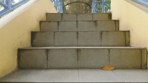 Low angle view of outdoor stone stairs with yellow walls and metal railing. Video stock 343372107