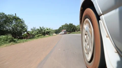 Low Angle View Outside Car Near Tire Driving On Road in Africa 스톡 동영상 102153930