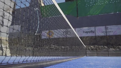 Low angle view of a padel tennis net on a blue court Stock Footage 299609145