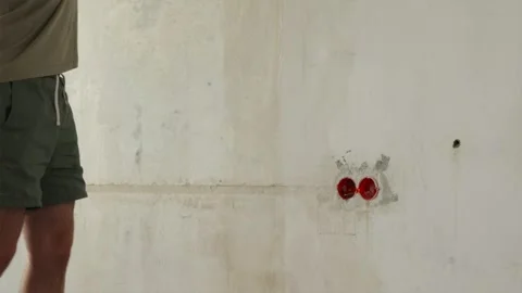 Low angle view of painter feet while rolling primer onto wall Stock Footage 340404000