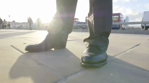 Low angle view pan around a businessman's feet Video stock 99209117