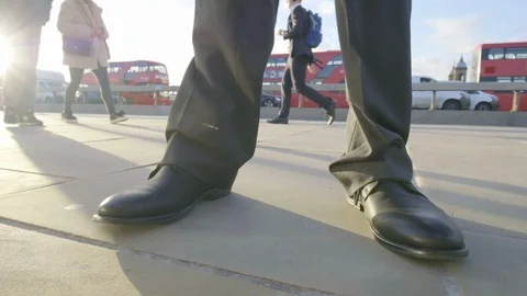 Low angle view pan around a businessman's feet Video stock 99209489