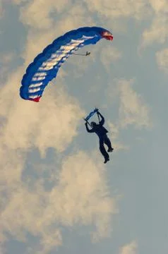 Low angle view of para-glider with blue parachute at sunset time Stock Photos