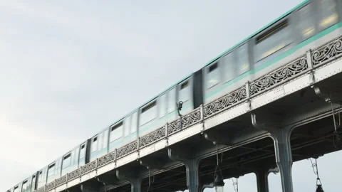 Low Angle View of a Paris Metro Train Passing Along the Ornate Upper Viaduct of  Stock Footage 338326888
