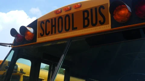 Low angle view of parked school bus on a sunny day. Video stock 56981001