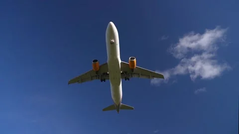 Low Angle View of Passenger Airplane with Yellow Engines in Smooth Motion Stock Footage 296056922
