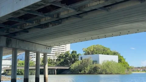 Low Angle View Passing Under Concrete Bridge on Urban River 库存影片 329097252