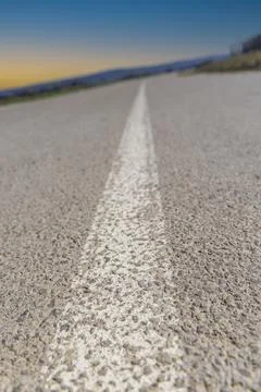 Low-angle view of a paved asphalt road with a white centerline Foto stock