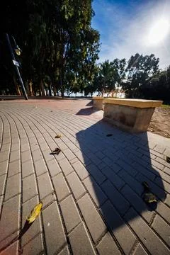 Low Angle View of Pavement and Bench Shadow at Torres Beach Stock Photos