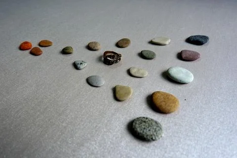 Low Angle View of Pebbles and Stacked Gold Rings on a Path 6814 Stock-Fotos