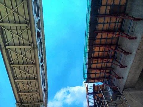 Low angle view pedestrian bridge and LRT station under construction. Stock Photos