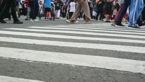 Low angle view of people and inline skates on a zebra crosswalk. Stock Footage 339172636