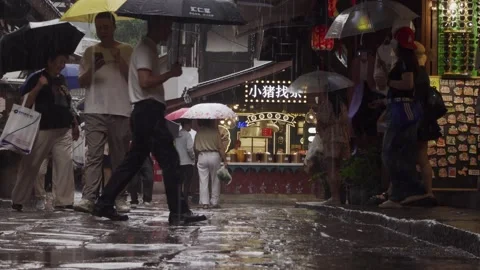 Low angle view of people on narrow, rainy street, Chongqing,4K Stock-Footage 339016801