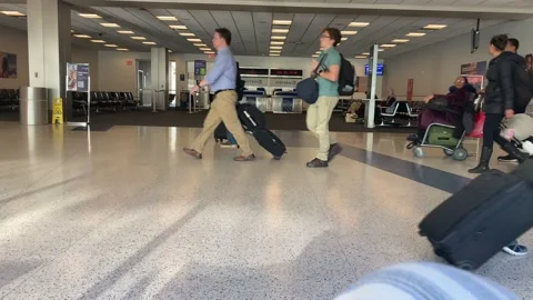 Low angle view of people walking in the airport 스톡 동영상 224608418