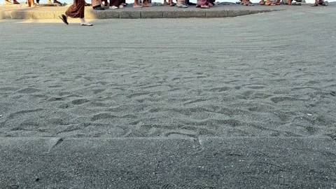 Low Angle View of People Walking on Paved Pathway near Sandy Ground Stock Footage 341320885