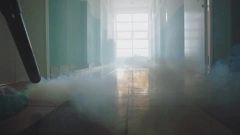 Low angle view of person in hazmat suit using fogging machine for professio.. Stock Footage 337467870