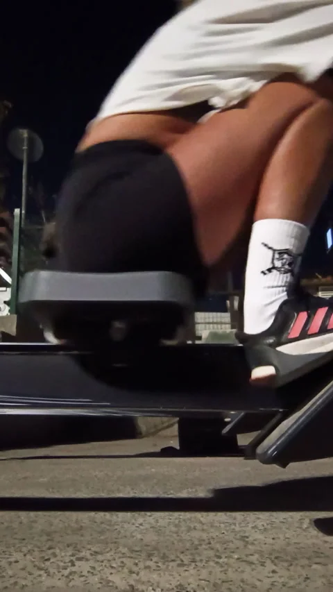 Low angle view of a person intensely working out on a rowing machine 動画素材 329830929