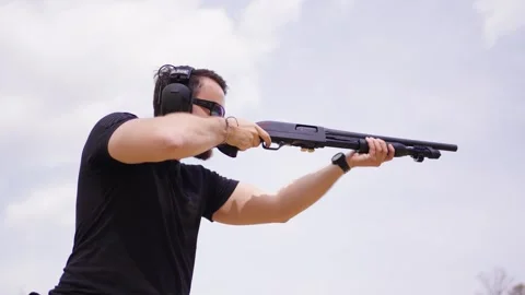 Low angle view of person shoot shotgun with muzzle blast shockwave visible 動画素材 275833850